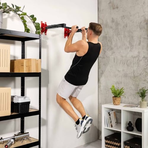 Man doing pull ups on Hop-Sport wall mounted pull up bar for upper body strength