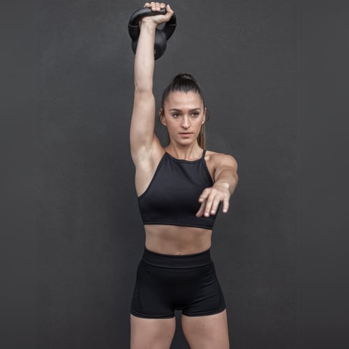 woman doing kettlebell snatch exercise