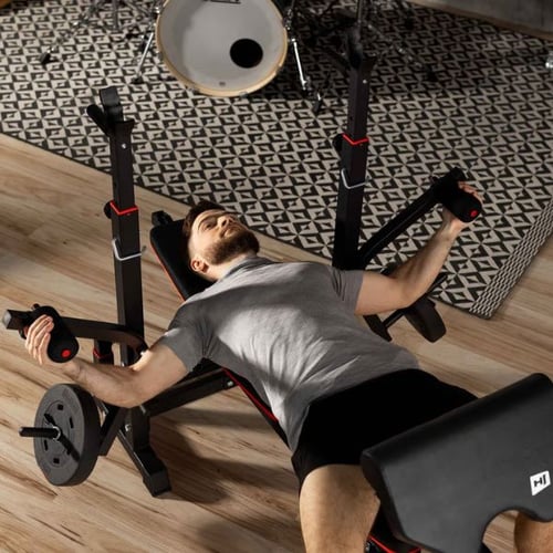 Man using Hop-Sport bench press station with butterfly arms during strength training