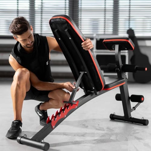Man adjusting the backrest angle of a multifunctional Hop-Sport workout bench with preacher pad