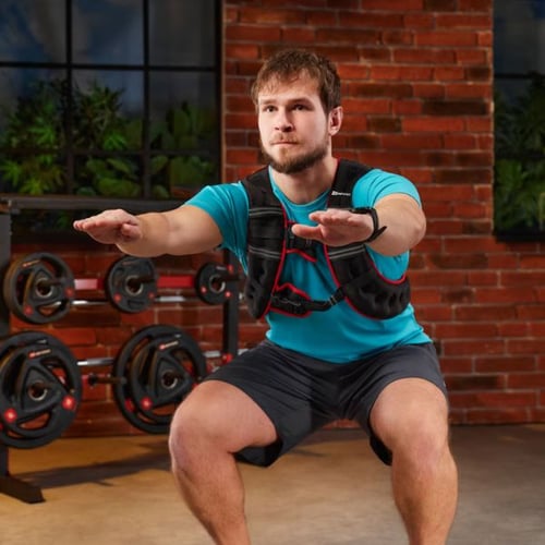 Man performing bodyweight squats while wearing a Hop-Sport weighted vest