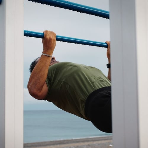 Man doing Australian Pull Up outdoors