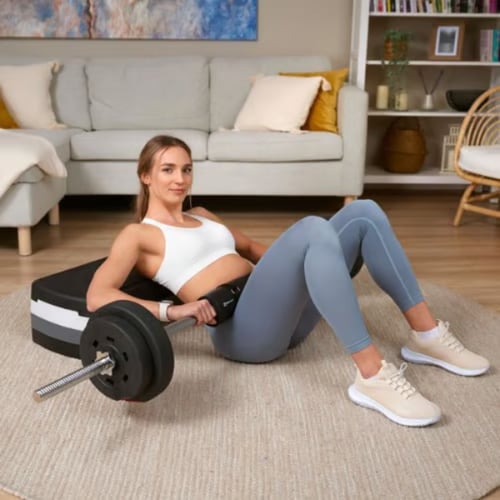 Woman doing a barbell hip thrust using a Hop-Sport barbell with upper back supported on a platform