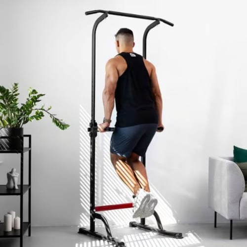 Man performing tricep dips on a Hop-Sport pull-up and dip station in a home settin