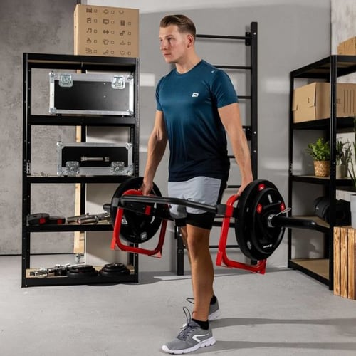 Man performing trap bar deadlift carry exercise with Hop-Sport hex bar and weight plates