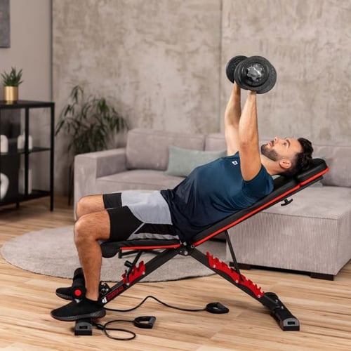 Man doing an incline dumbbell chest press on a red and black Hop-Sport weight bench in a home setting