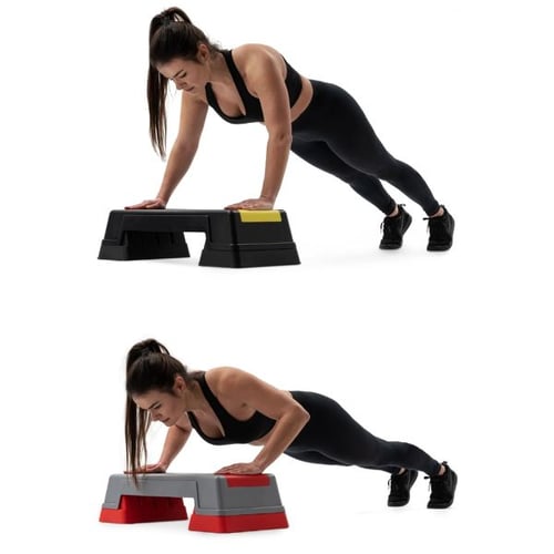 Woman doing elevated push-ups on Hop-Sport aerobic step platform targeting chest, shoulders, and core muscles