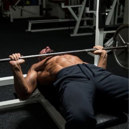 Bench press with barbell on weight bench