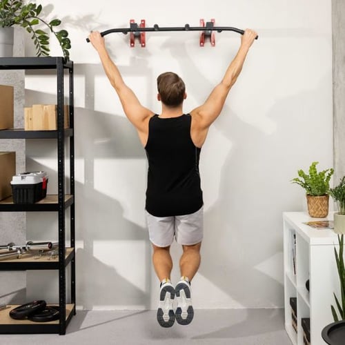 Man hanging from Hop-Sport wall mounted pull up bar before starting pull ups