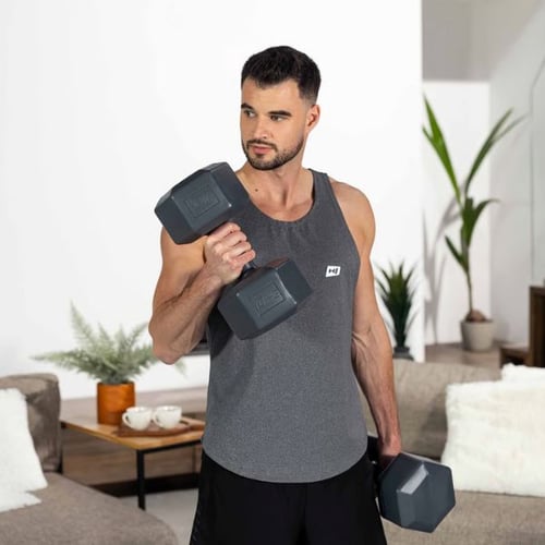 Man performing bicep curl with Hop-Sport hex dumbbells at home