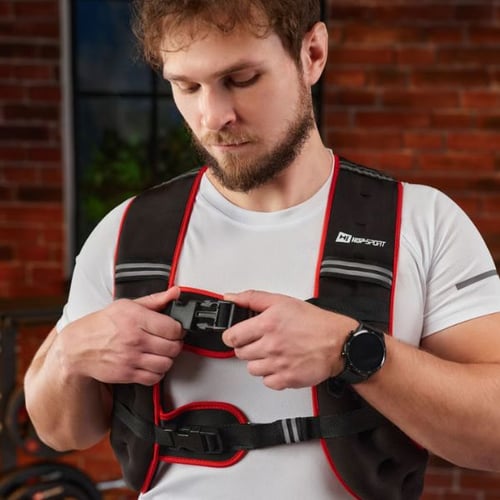 Man fastening the straps of a Hop-Sport weighted vest before training