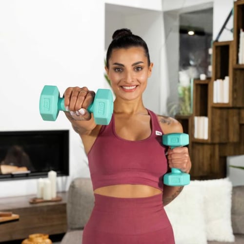 a woman holding light dumbbells out in front at shoulder level