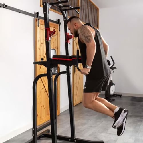 Man doing tricep dips using a Hop-Sport power tower with padded armrests and back support
