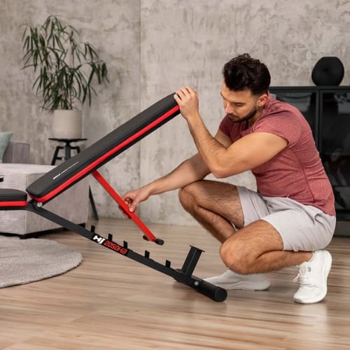 Man adjusting the backrest angle of the Hop-Sport HS-1055 incline weight bench in a home gym