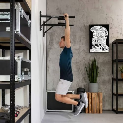 Man hanging from Hop-Sport wall-mounted pull-up bar preparing to do a pull up