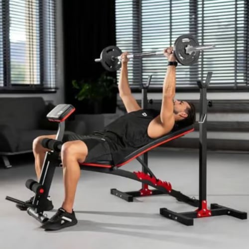 Man performing incline bench press on Hop-Sport adjustable weight bench with barbell