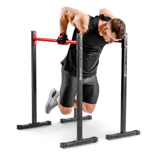 Man training triceps with bodyweight dips on Hop-Sport parallel bars with red crossbar